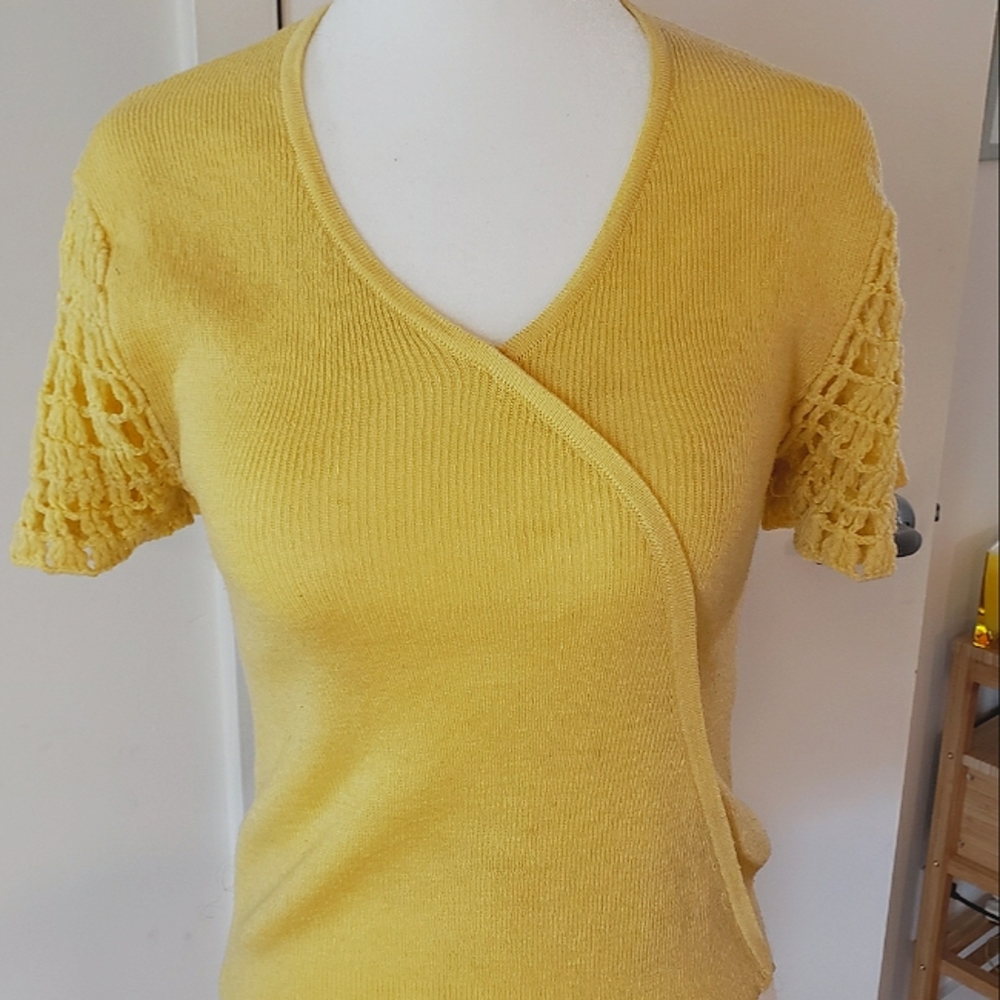 Vinatge knit sweater with a diagonal front closure and crochet sleeves.